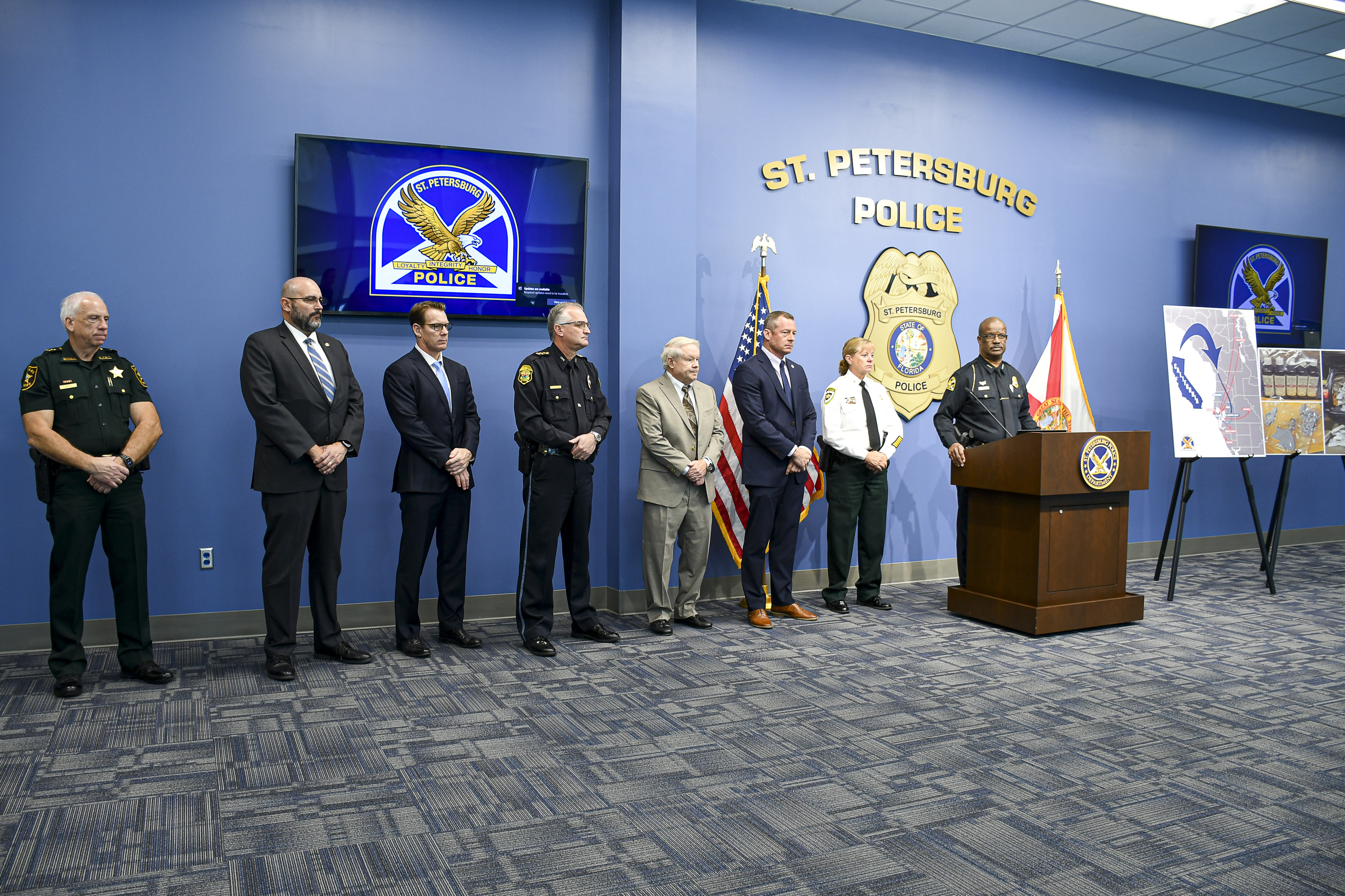 Agencies involved in drug bust standing at podium