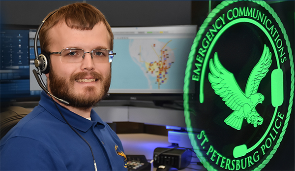 male communications employee standing next to the communications center logo