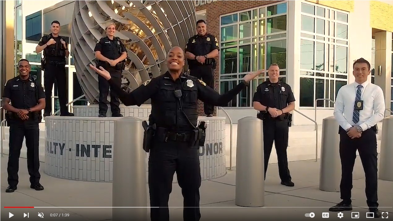 officers standing in front of police station. recruiting video for officers. youtube thumbnail